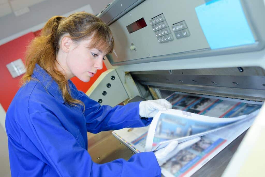 Woman examining print materials for custom finishing