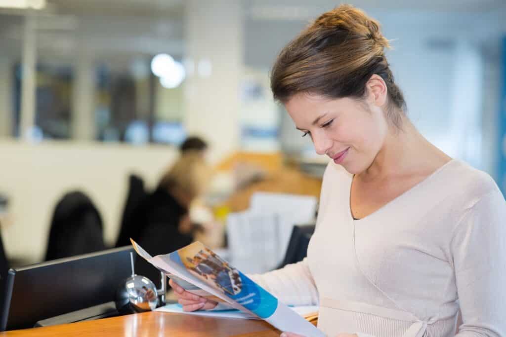 Woman reading a business brochure
