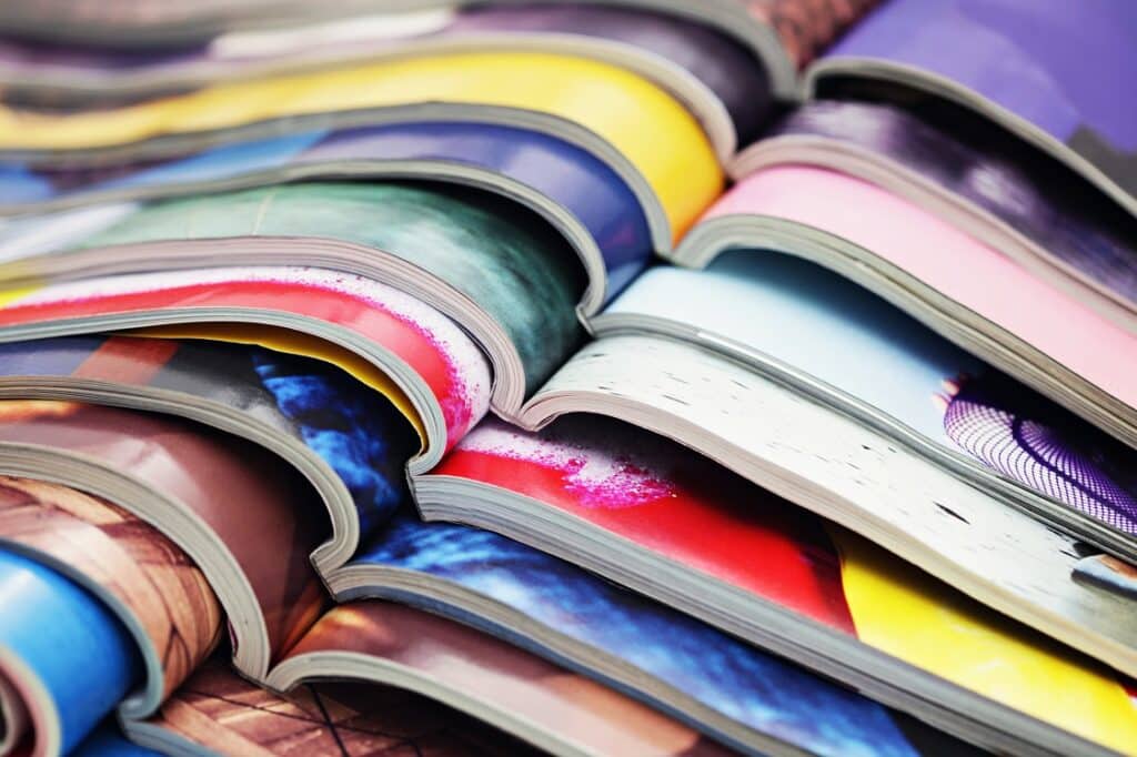 Stack of magazines shows businesses taking advantage of cheap magazine printing