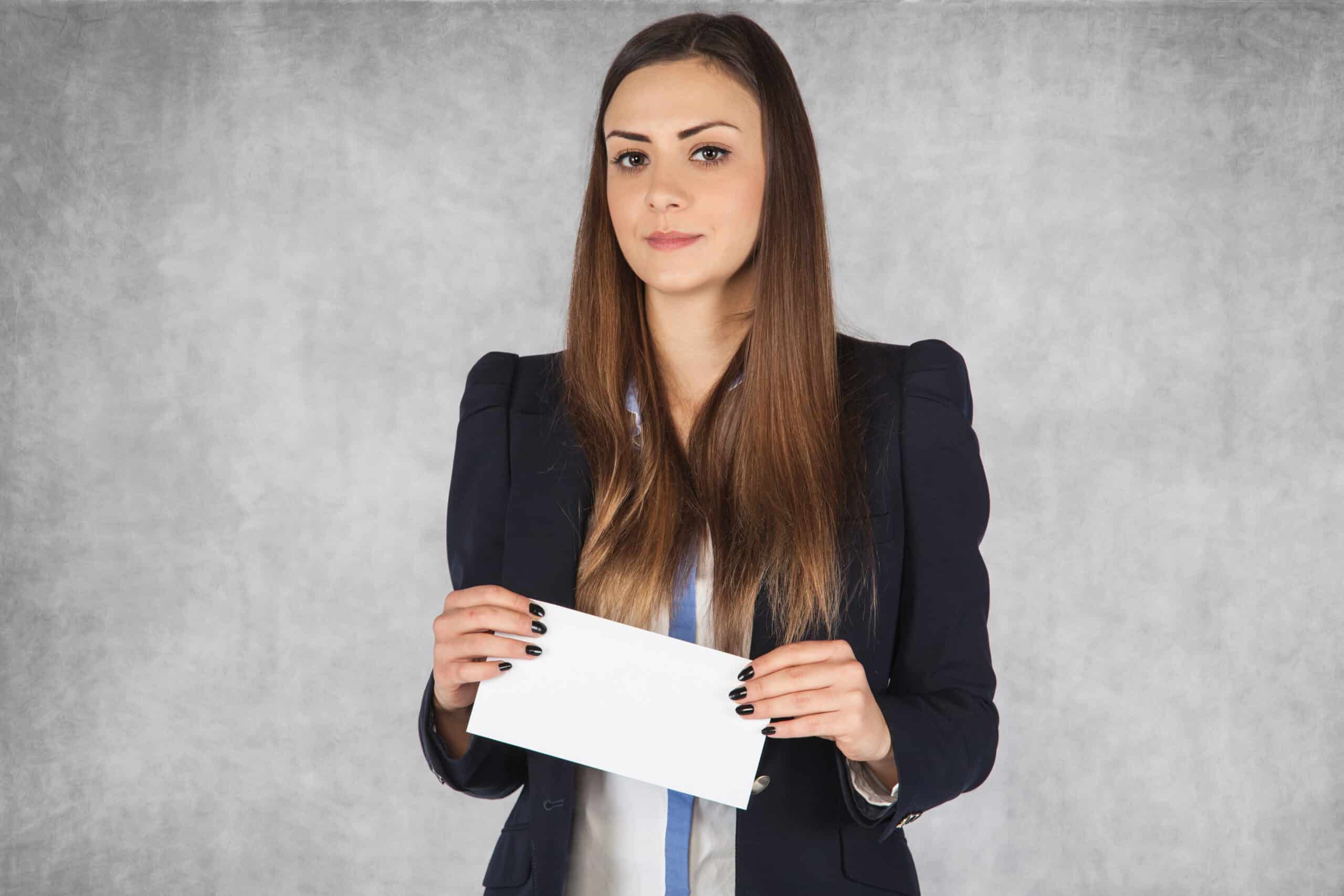 a woman holding a #10 envelope