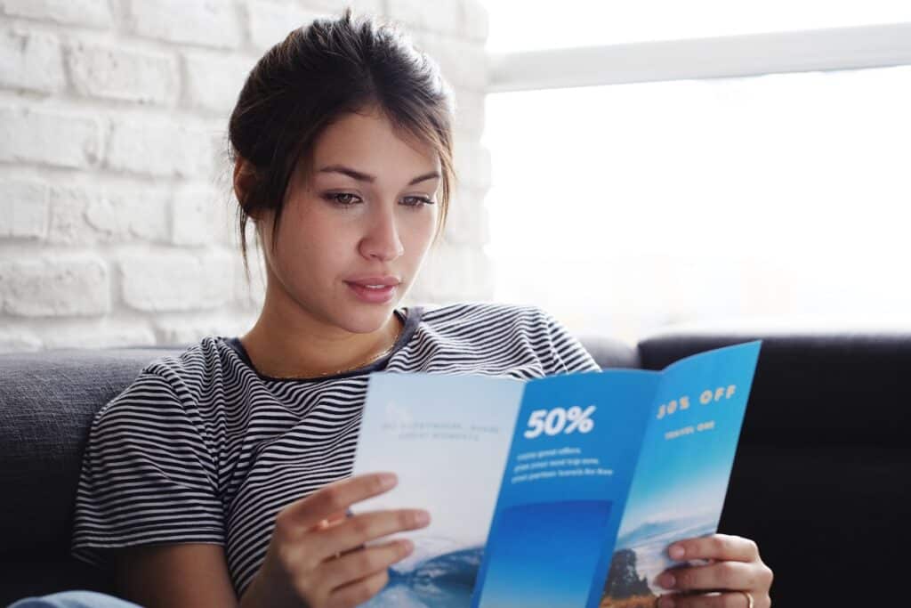 Woman wants to purchase products thanks to affordable brochure printing